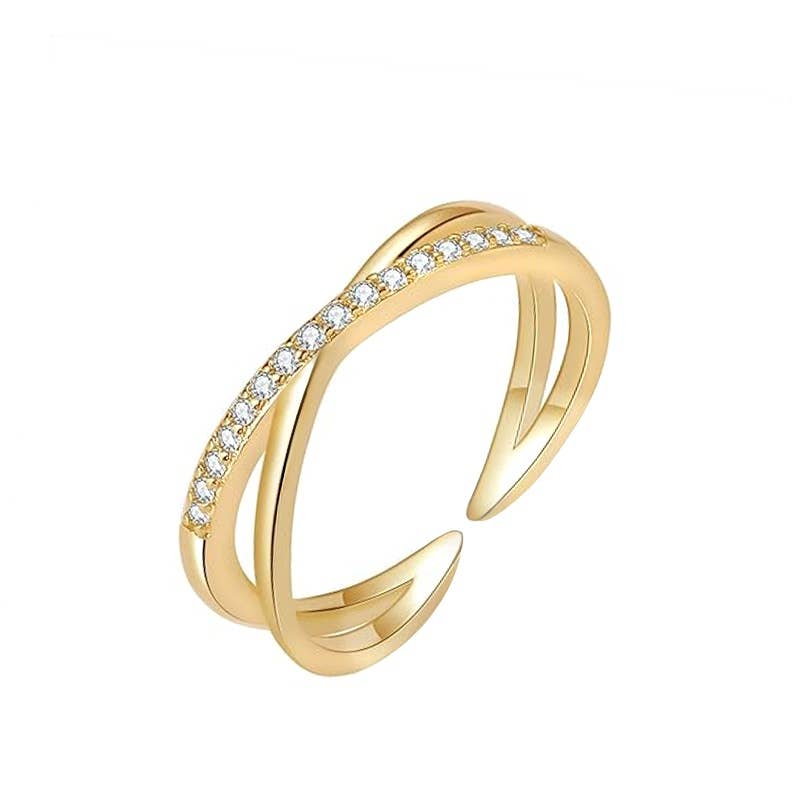 Bague dorée ouverte et réglable au design de vagues croisées en acier inoxydable et oxydes de zirconium.