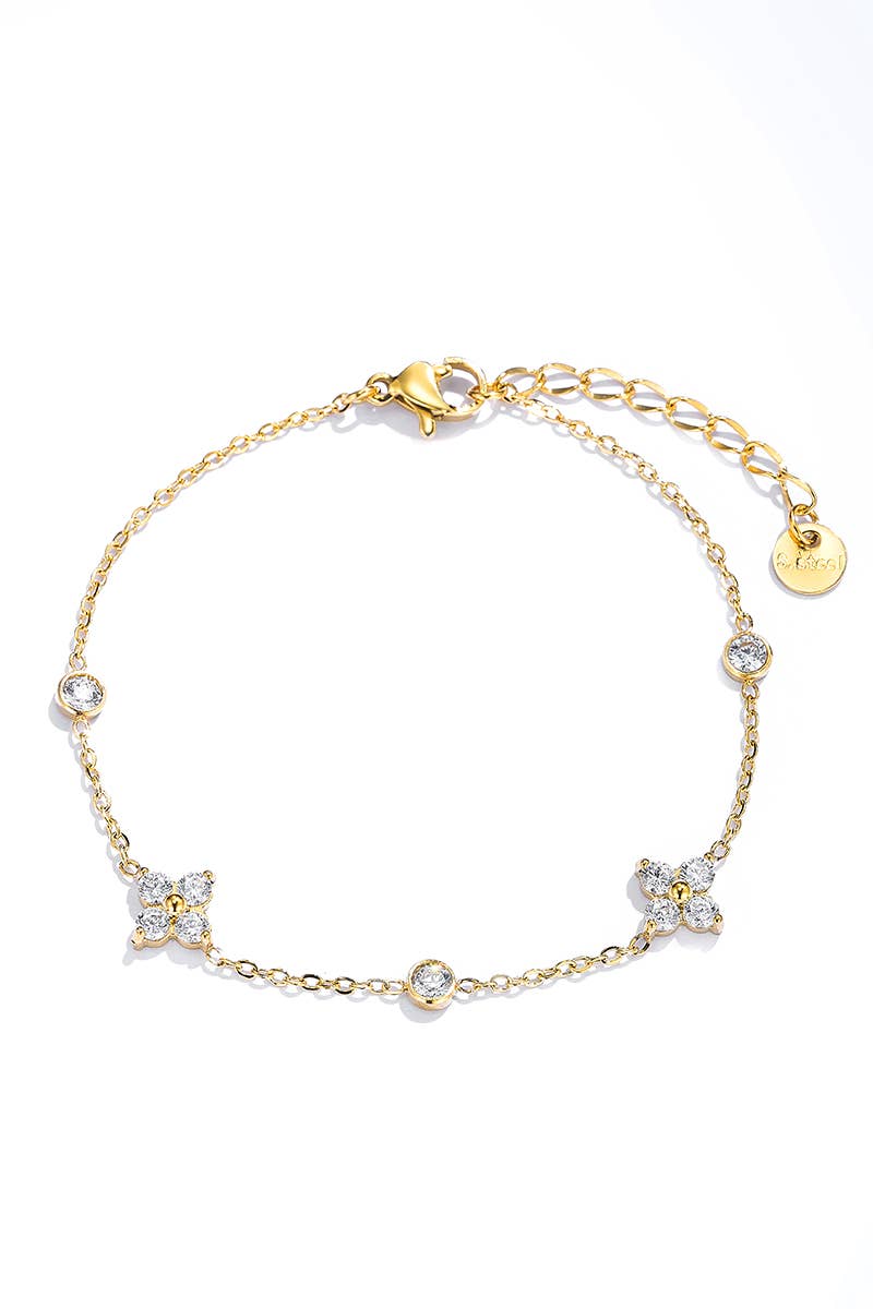 Chaîne de cheville dorée pour femme en acier inoxydable avec motifs fleurs en strass et pampilles de cristaux ronds sertis clos.