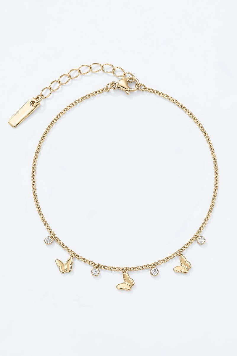 Chaîne de cheville dorée pour femme en acier inoxydable avec breloques papillons bombés et cristaux blancs suspendus.