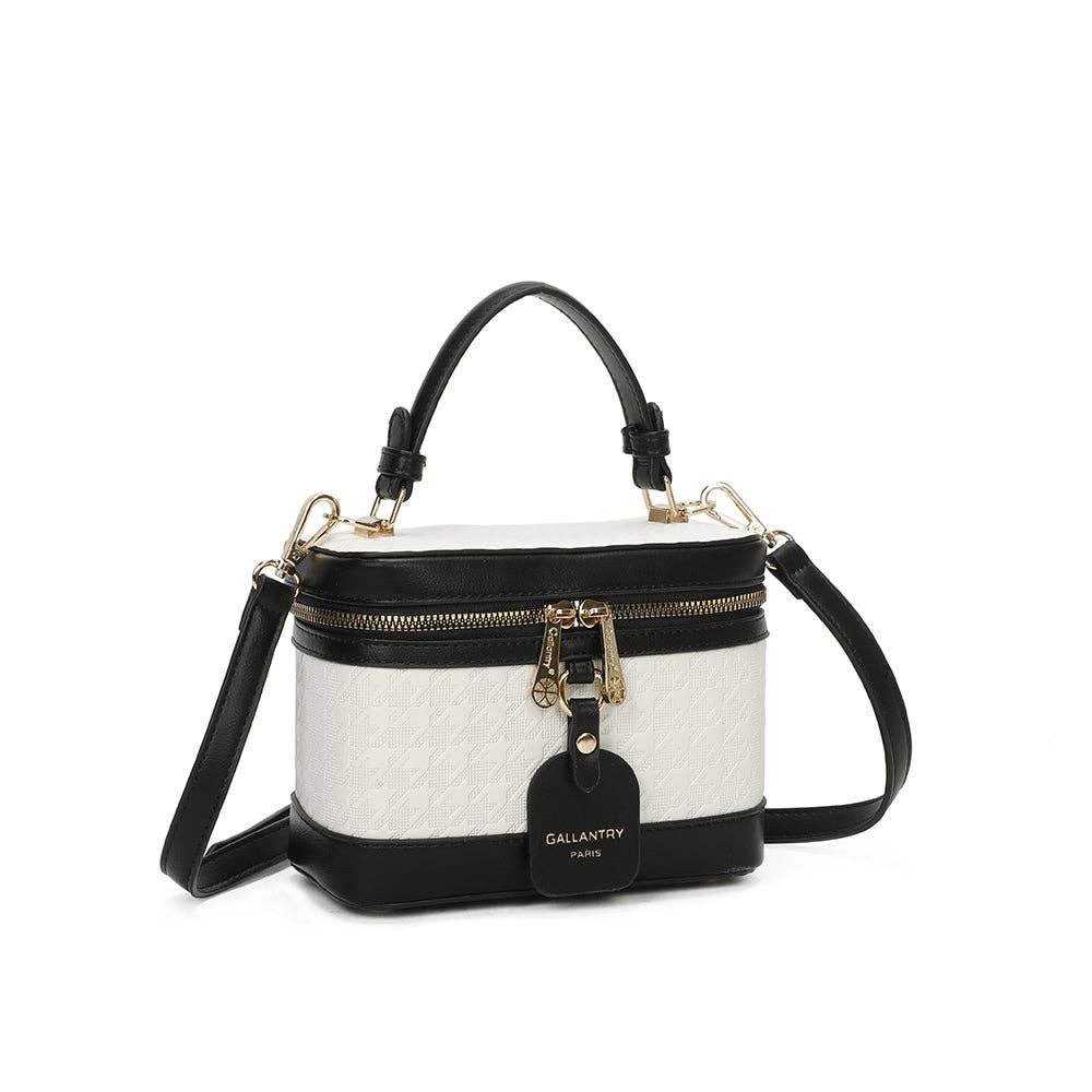 Mini sac à main rigide de forme vanity Le Bambino blanc et noir (REF 11) par Gallantry Paris, avec motif texturé en relief, poignée supérieure, bandoulière noire et clochette en cuir suspendue, vu de face sur fond blanc.