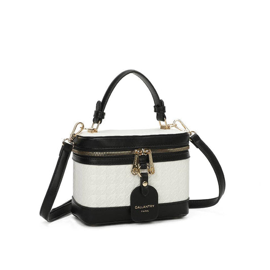 Mini sac à main rigide de forme vanity Le Bambino blanc et noir (REF 11) par Gallantry Paris, avec motif texturé en relief, poignée supérieure, bandoulière noire et clochette en cuir suspendue, vu de face sur fond blanc.